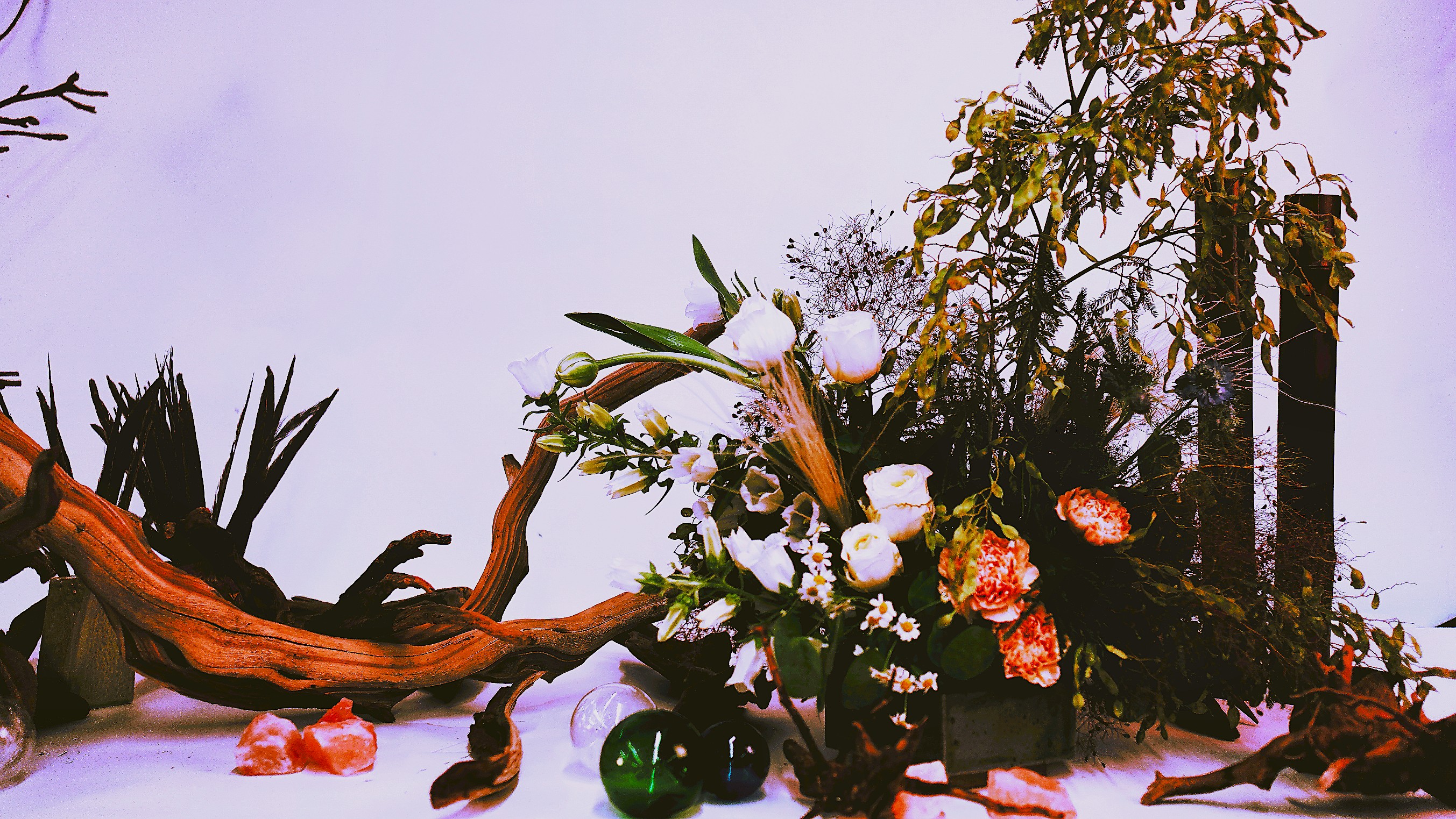 Driftwood and cut flowers on a table